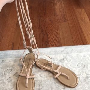 Nude/tan sandals that wrap around calf.
